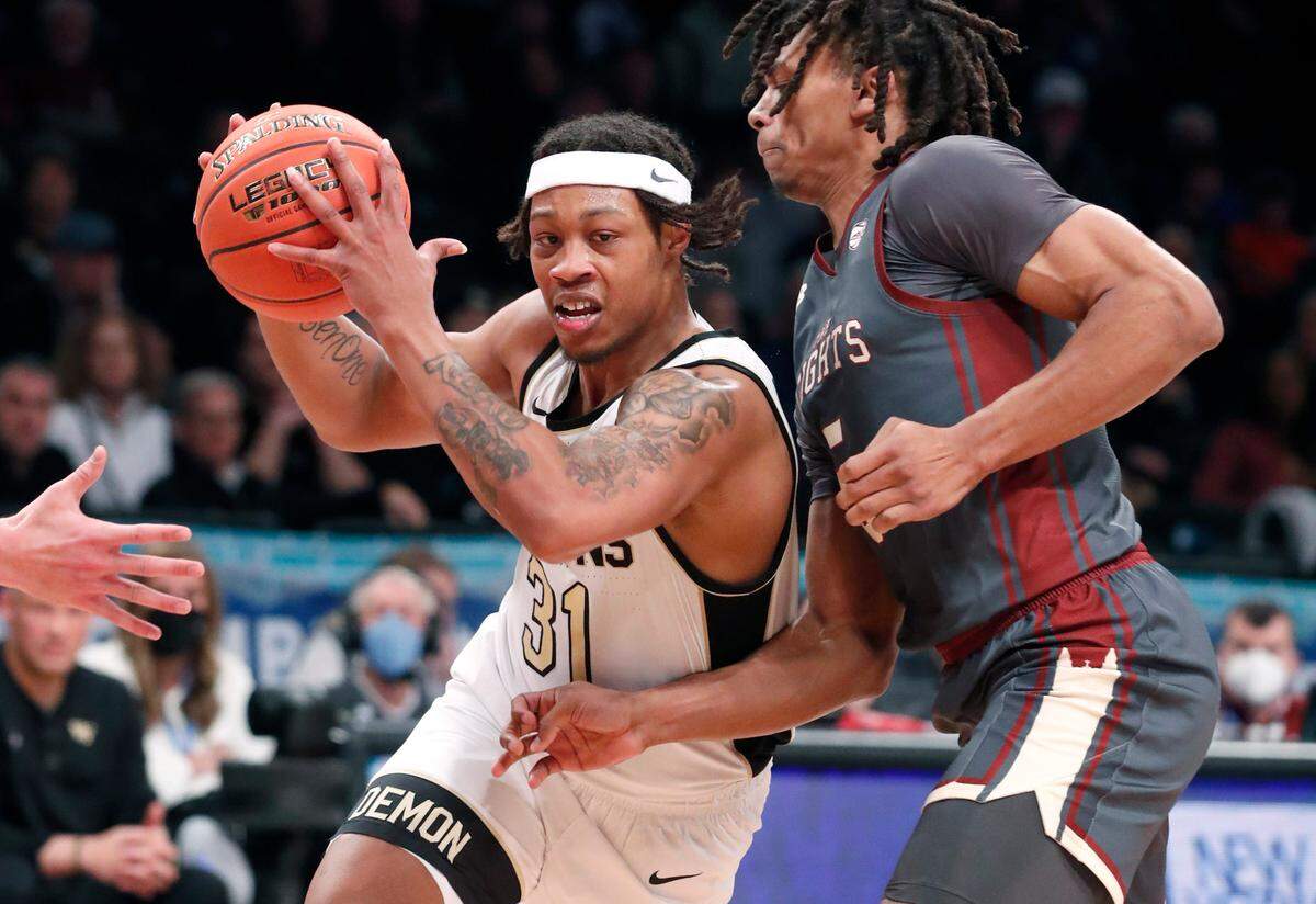 Wake Forest’s Alondes Williams (31) drives by Boston College’s DeMarr Langford Jr. (5) during Boston College’s 82-77 overtime victory over Wake Forest during the second day of the ACC men’s basketball tournament at the Barclays Center in Brooklyn, N.Y., Wednesday, March 9, 2022.