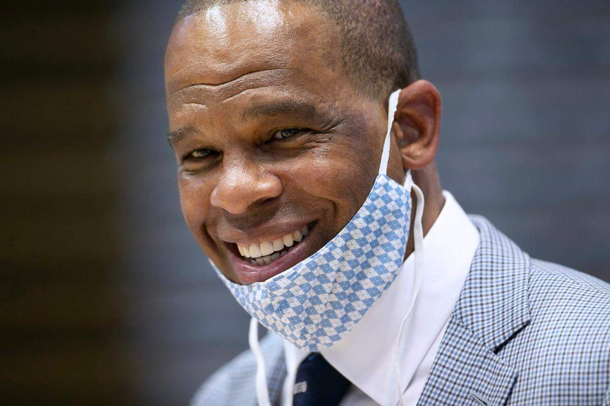 Hubert Davis flashes a smile as he visits with friends and family after he was introduced at the new menís basketball coach at the University of North Carolina on Tuesday, April 6, 2021 at the Smith Center in Chapel Hill, N.C.