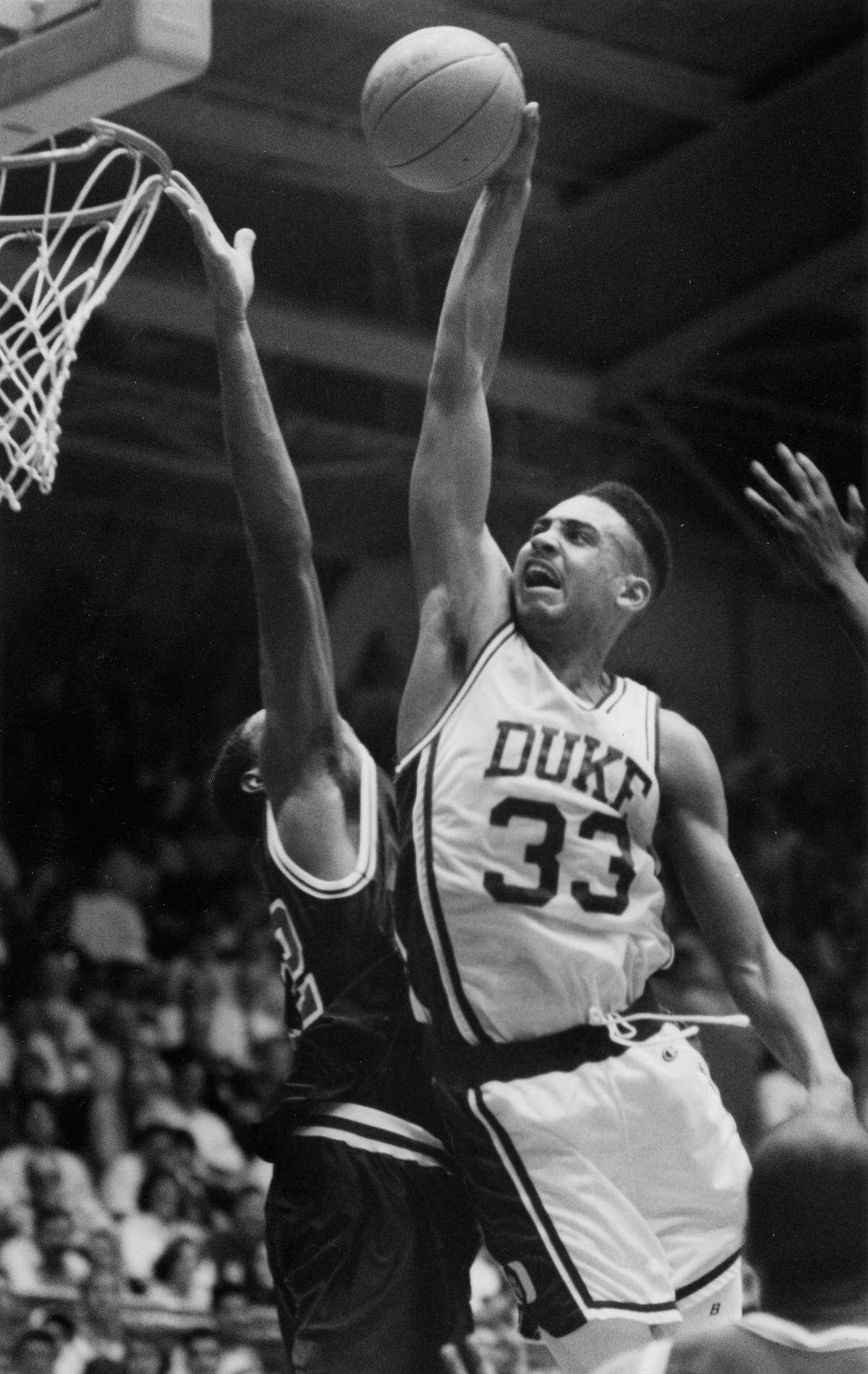 Duke’s Grant Hill flies toward the basket for a dunk during an exhibition game against America High Five Nov 16, 1991.