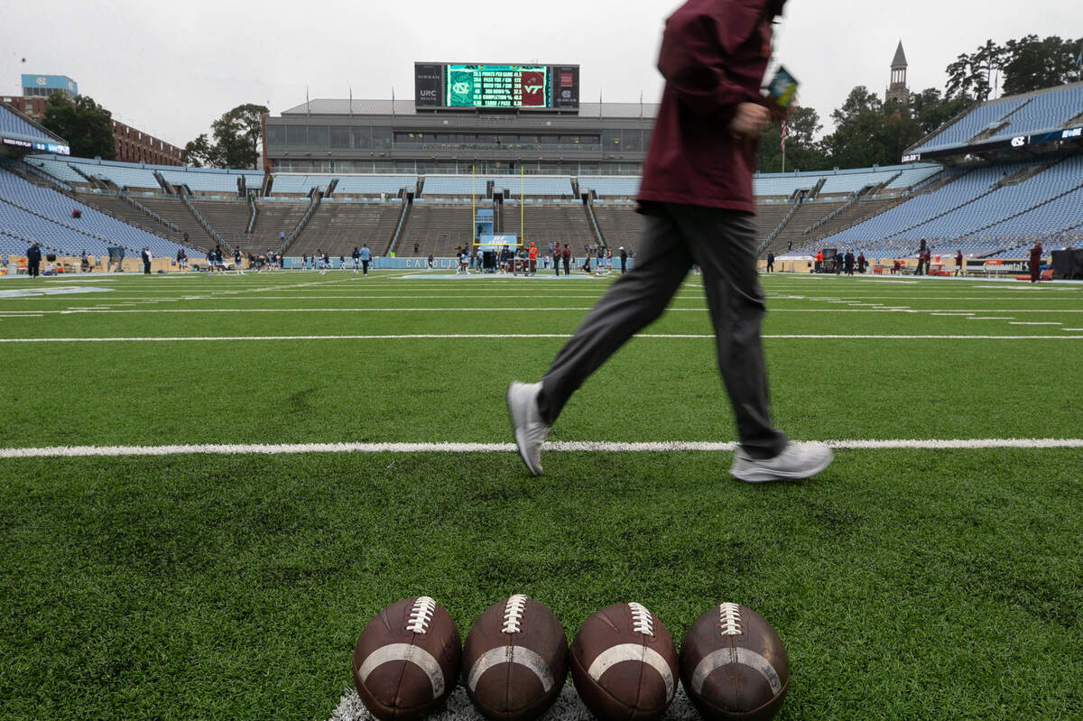 Players and staff from Virginia Tech and North Carolina take to the field for their pre-game warmups on Saturday, October 10, 2020 at Kenan Stadium in Chapel Hill, N.C. Under new COVID-19 guidelines 3500 people were allowed into the stadium for the game Saturday.