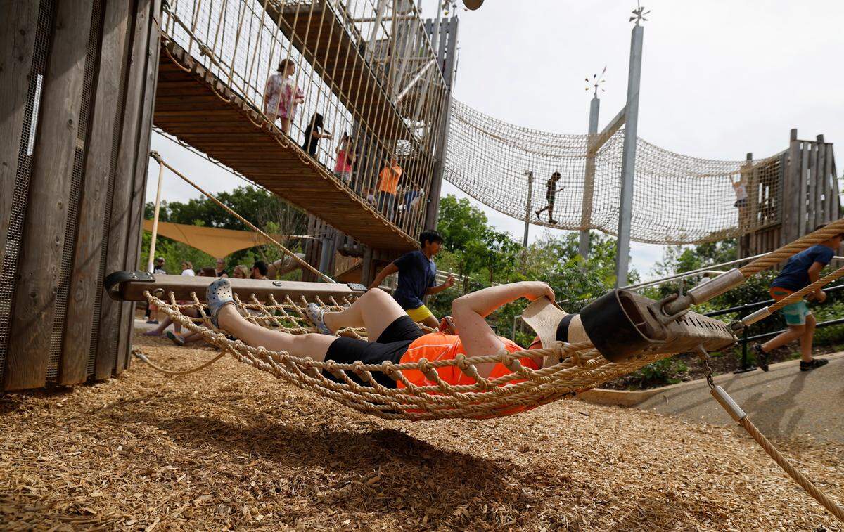 Liz Zatz of Raleigh takes a break on a hammock at Gipson Play Plaza at Dix Park during a preview day Saturday, May 24, 2025. The park will officially open with a grand opening celebration on June 6th, 7th and 8th.