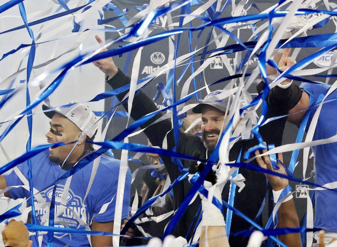 Duke head coach Manny Diaz celebrates as streamers fall following the Blue Devils’ 27-20 overtime victory over Virginia in the ACC Football Championship on Saturday, Dec. 6, 2025, at Bank of America Stadium in Charlotte, N.C.