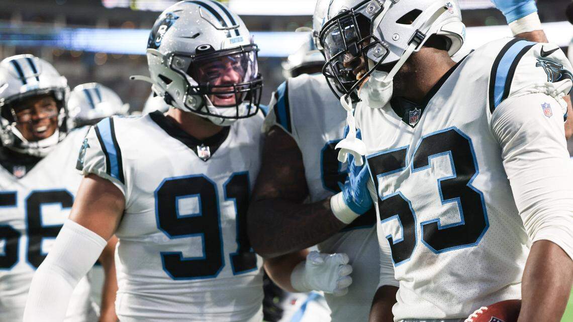 Carolina Panthers Brian Burns, right, celebrates an interception at the Bank of America Stadium in Charlotte, N.C., on Friday, August 27, 2021.

