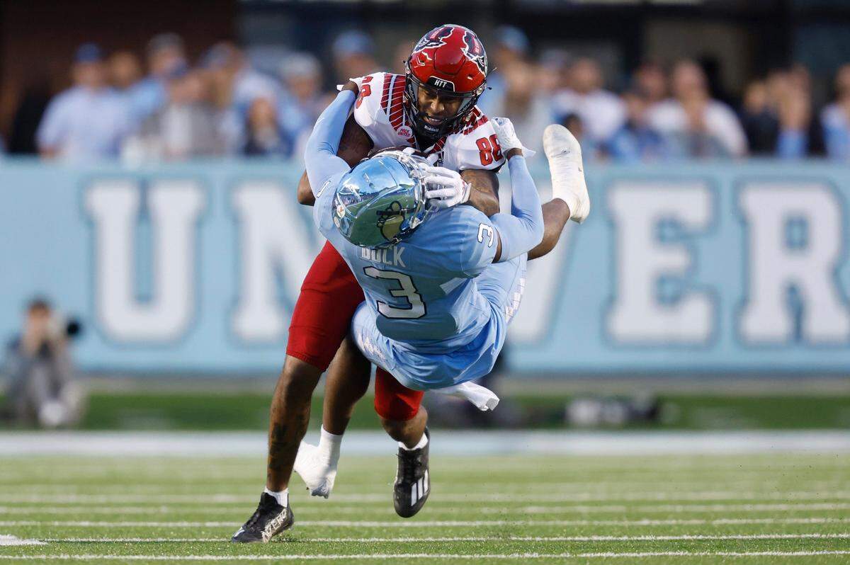 N.C. State wide receiver Devin Carter (88) is tackled by North Carolina defensive back Storm Duck (3) during the first half of N.C. State’s game against UNC at Kenan Stadium in Chapel Hill, N.C., Friday, Nov. 25, 2022.