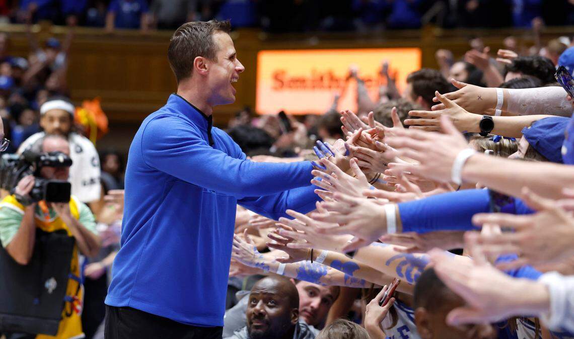 Duke head coach Jon Scheyer greets the Cameron Crazies after Blue Devils’ 71-67 victory over N.C. State at Cameron Indoor Stadium in Durham, N.C., Tuesday, Feb. 28, 2023.