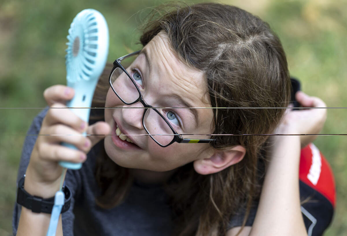 Stetson Salestron of Wendell, NC uses a handheld fan to keep cool during the Freedom Fest 250, celebrating the country’s Semiquincentennial, at the North Carolina State Capitol, on Saturday, July 4, 2026 in Raleigh, N.C.