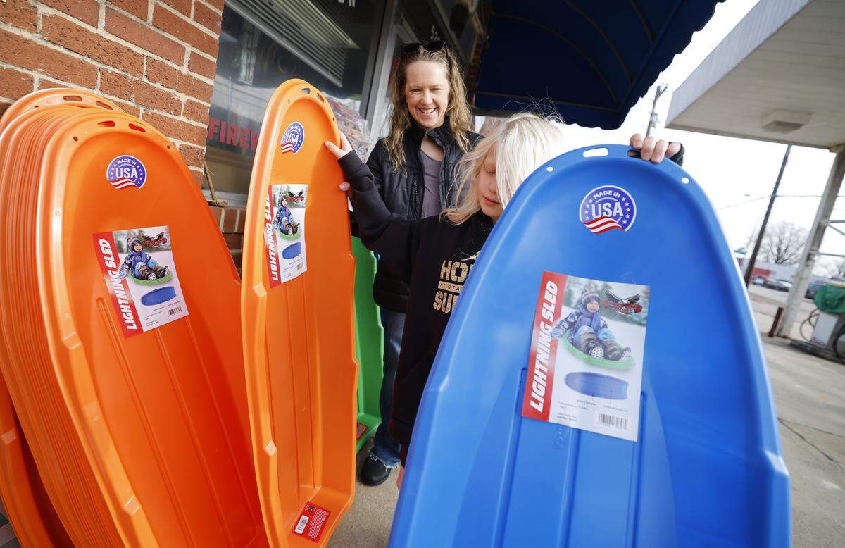 Tyler Rowe, 8, of Raleigh and his mother Traci choose sleds after purchasing them at Smith Hardware and Garden in Raleigh, N.C., Friday morning Jan. 30, 2026.