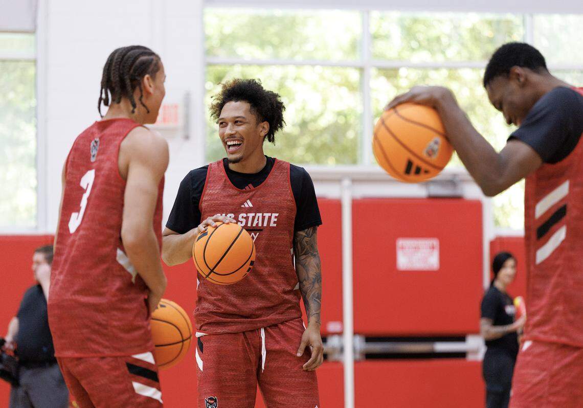 N.C. State’s Darrion Williams, center, laughs with teammates Matt Able and Terrence Arceneaux at the start of the Wolfpack’s first official practice at Dail Basketball Center on Monday, Sept. 22, 2025, in Raleigh, N.C.
