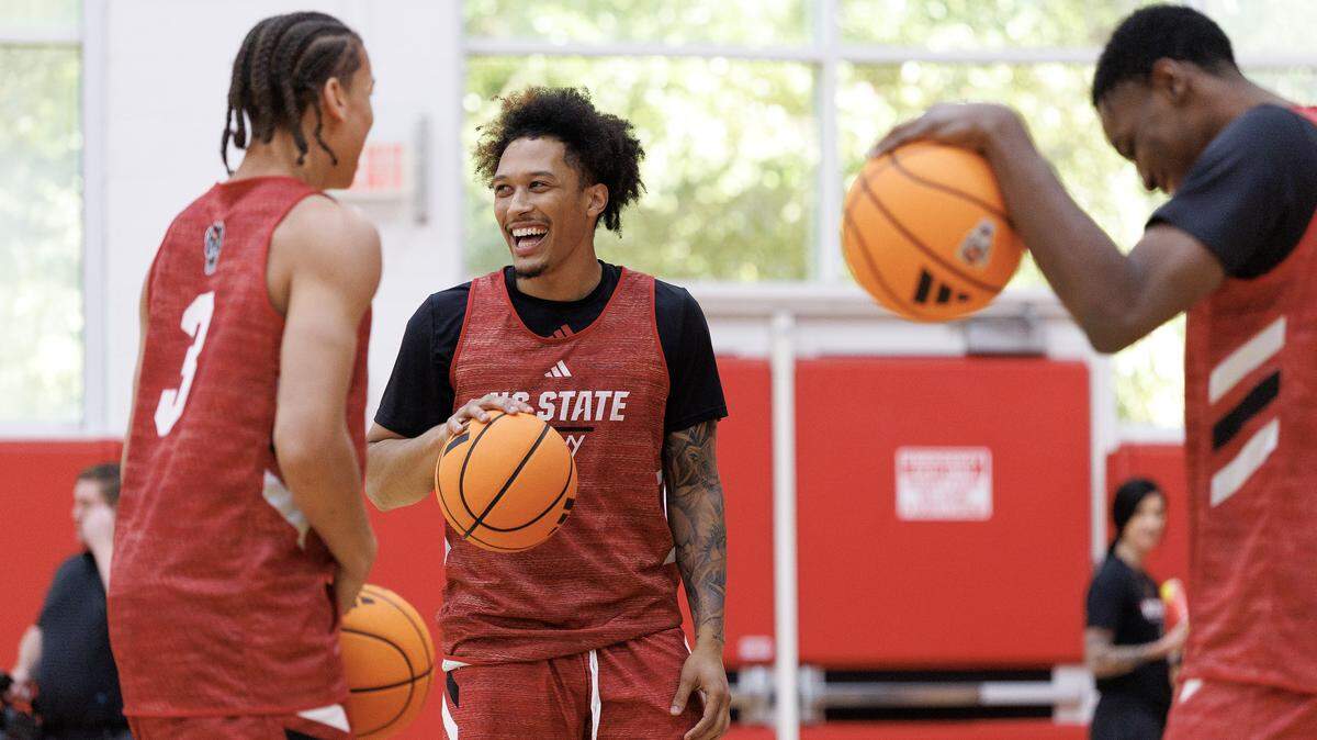 N.C. State’s Darrion Williams, center, laughs with teammates Matt Able and Terrence Arceneaux at the start of the Wolfpack’s first official practice at Dail Basketball Center on Monday, Sept. 22, 2025, in Raleigh, N.C.
