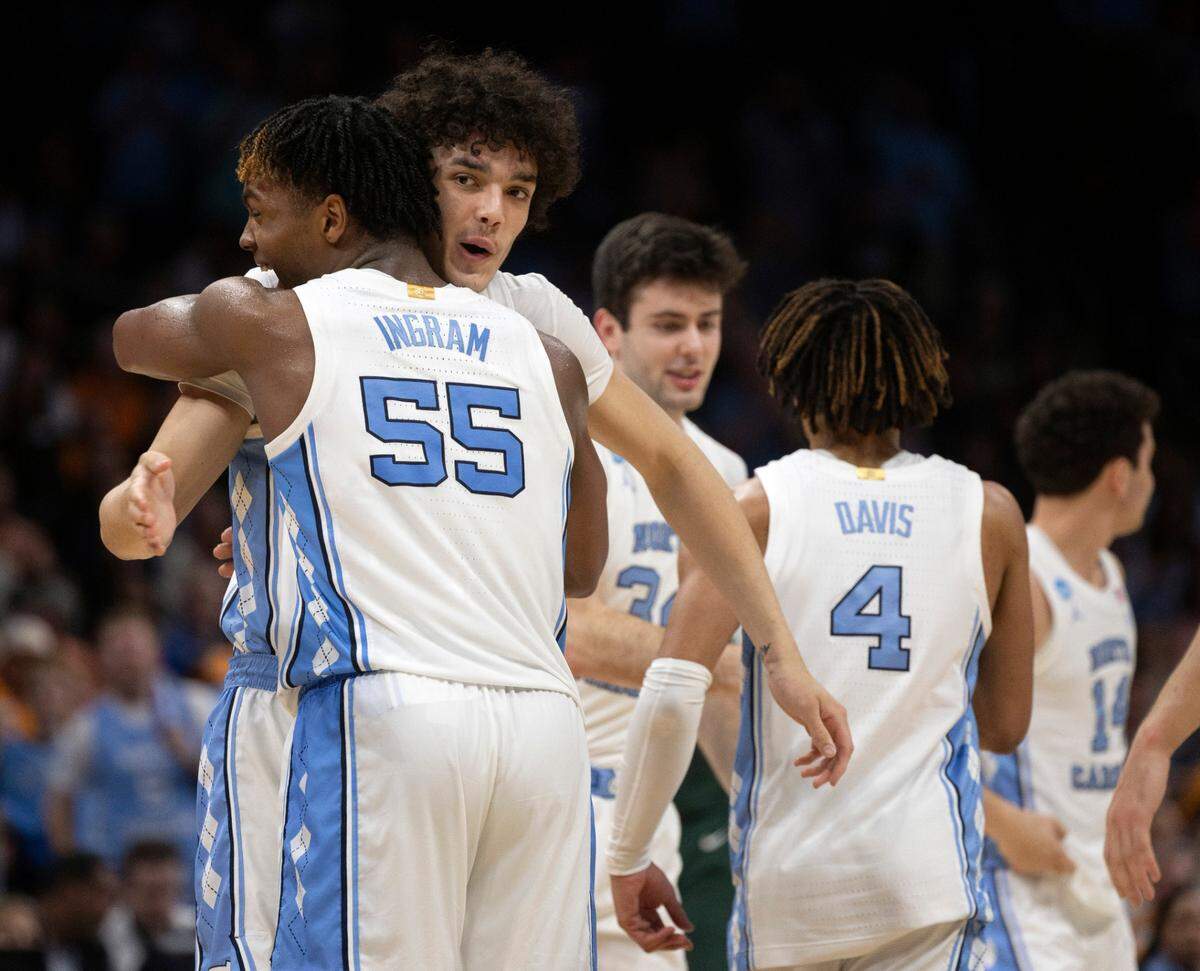 North Carolina’s Harrison Ingram (55) embraces Zayden High (1) as he comes of the game in the closing minutes of play against Michigan State on Saturday, March 23, 2024, during the second round of the NCAA Tournament at Spectrum Center in Charlotte, N.C. Ingram scored 17 points in the victory.