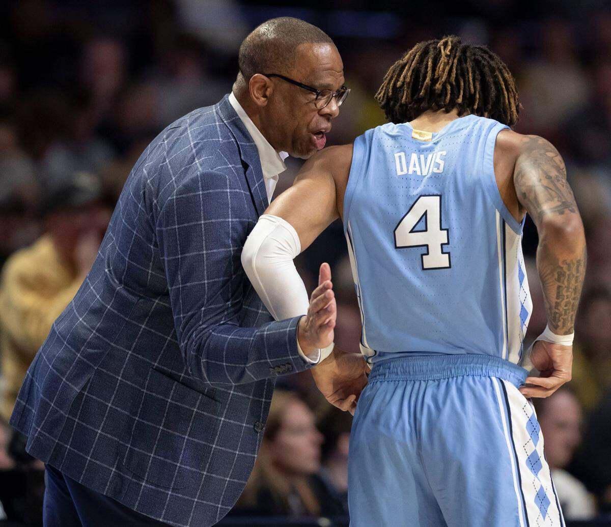North Carolina coach Hubert Davis talks with R.J. Davis (4) in the first half against Wake Forest on Tuesday, January 21, 2025 at Lawrence Joel Coliseum in Winston-Salem, N.C.
