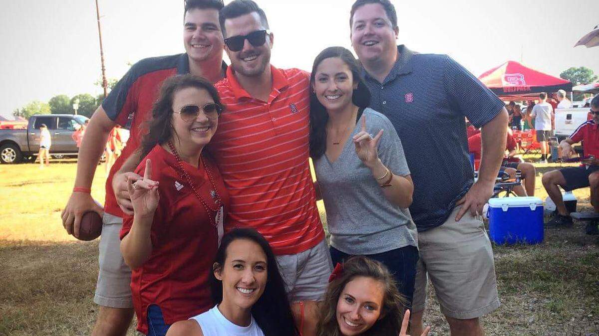 Jonathan Ray (middle, sunglasses) and his wife, Marisa (bottom right) are among the hundreds of fans who will have to find new tailgate spots near Carter-Finley Stadium for the 2018 season.