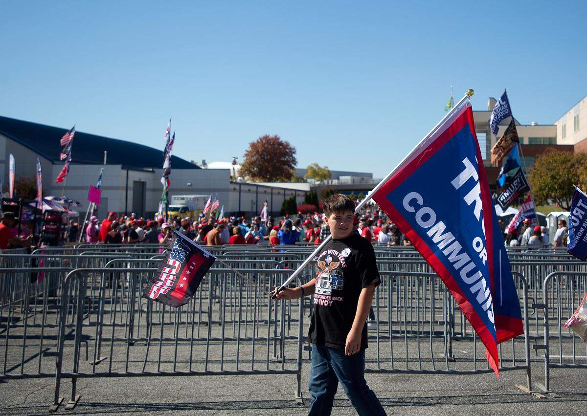 Supporters of former President and Republican presidential candidate Donald Trump gather outside the Greensboro Coliseum Complex on Tuesday, Oct. 22, 2024, in Greensboro, N.C.