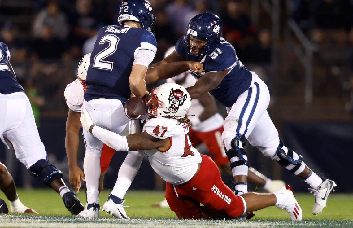 N.C. State defensive lineman Red Hibbler (47) sacks Connecticut quarterback Joseph Fagnano (2) causing him to fumble during the second half of N.C. State’s 24-14 victory over UConn at Rentschler Field in East Hartford, Conn. Thursday, August 31, 2023. Fagnano recovered his fumble.