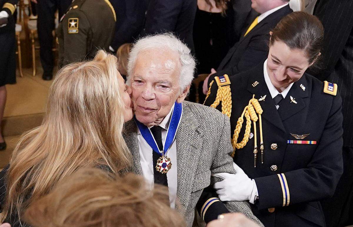 Capt. Rebecca Lobach (right) escorts Ralph Lauren after he was awarded the Presidential Medal of Freedom during a ceremony in the East Room of the White House on Saturday January 4, 2025.