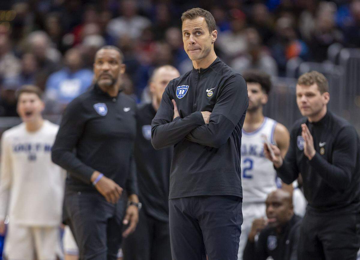 Duke coach Jon Scheyer, eyes the scoreboard as the Blue Devils pull within two point of St. John’s in the first half during the Sweet Sixteen of the NCAA Tournament on Friday, March 27, 2026, at Capital One Arena in Washington, D.C.