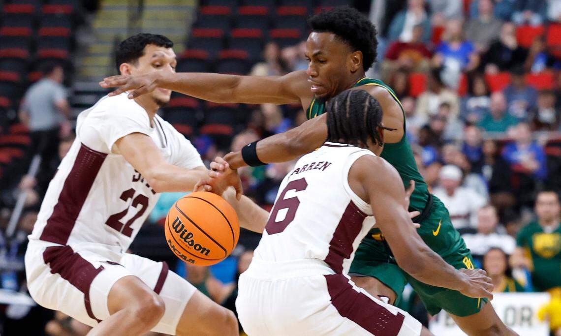 Baylor’s Jeremy Roach (3) drives between Mississippi State’s RJ Melendez (22) and Dellquan Warren (6) during the first half of Baylor’s game against Mississippi State in the first round of the 2025 NCAA Men’s Basketball Tournament at the Lenovo Center in Raleigh, N.C., Friday, March 21, 2025.