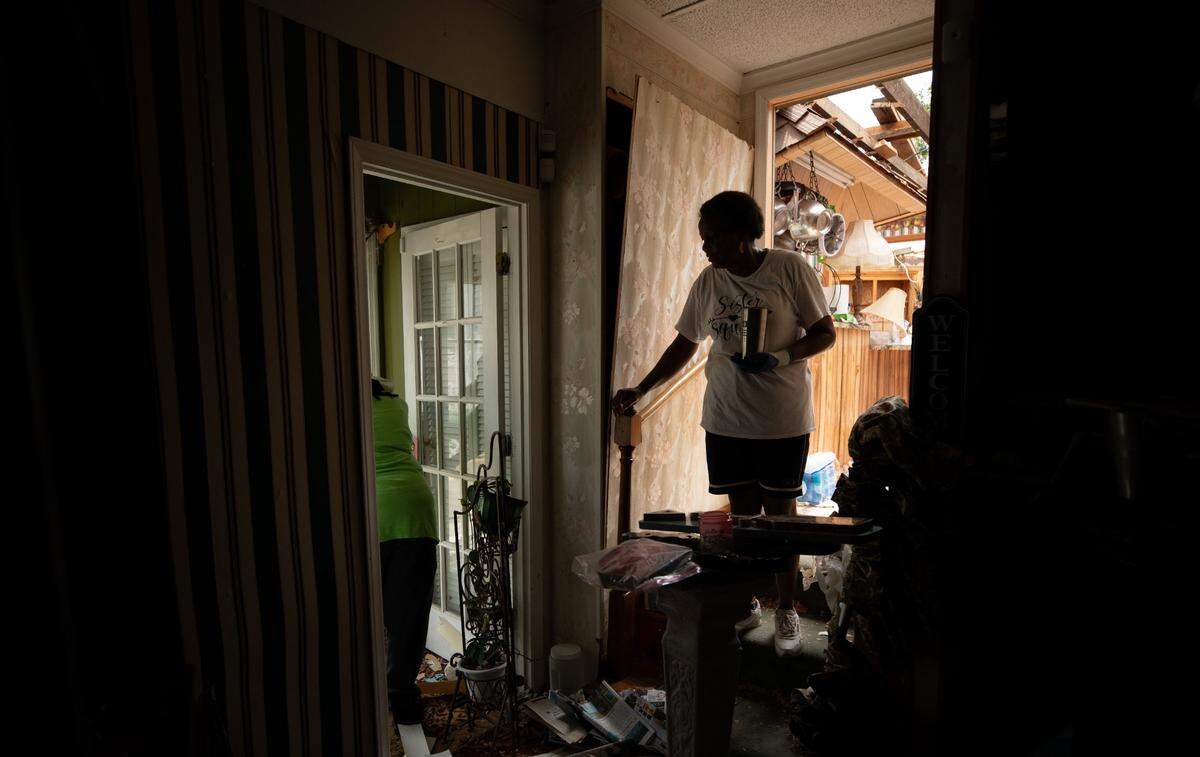 Evelyn Powell stands in the doorway to her kitchen on Thursday, July 20, 2023. Evelyn and James Powell’s house, situated on 7 Bridges Rd. east of Battleboro, N.C., was hit by the tornado on Wednesday afternoon. James said he was standing in the house watching the news when the roof lifted off the place. The two have lived in the house for over 40 years. Photo by Anna Connors, The News & Observer