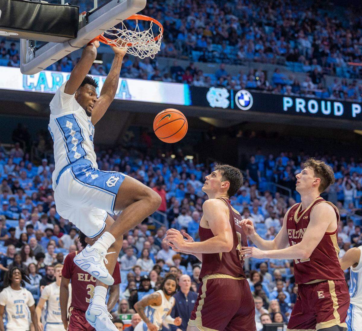 North Carolina forward Jalen Washington (13) gets a dunk over Elon’s Sam Sherry (4) and Isaac Harrell (12) during the second half on Monday, November 4, 2024 at the Smith Center in Chapel Hill, N.C.