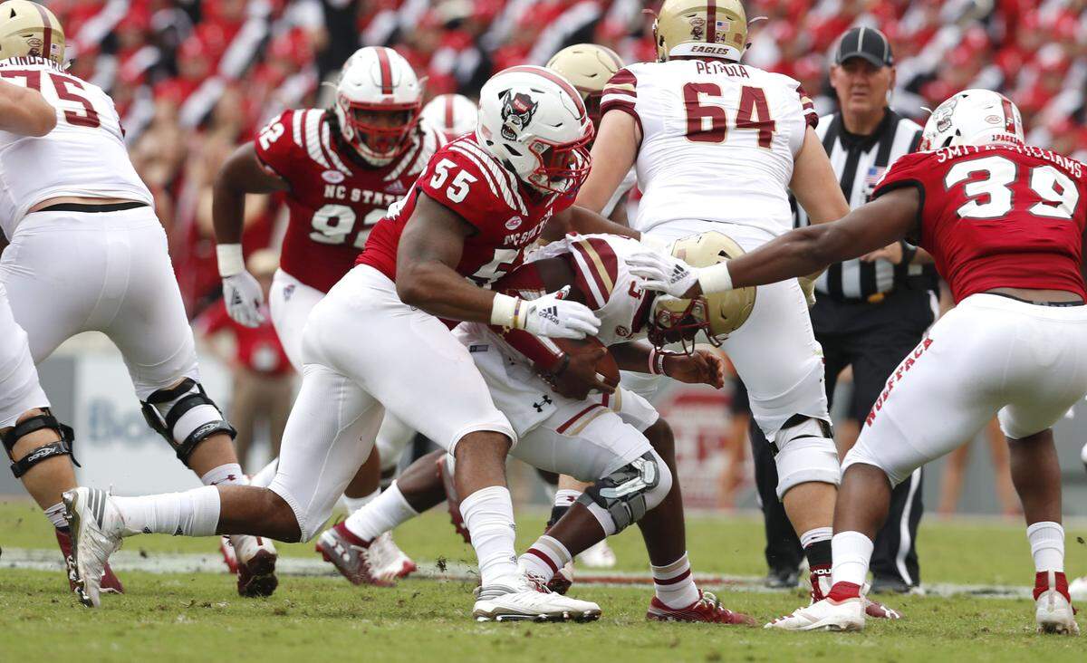 N.C. State defensive end Deonte Holden (55) sacks Boston College quarterback Anthony Brown (13) during the first half of N.C. State’s game against Boston College at Carter-Finley Stadium in Raleigh, N.C., Saturday, Oct. 6, 2018.