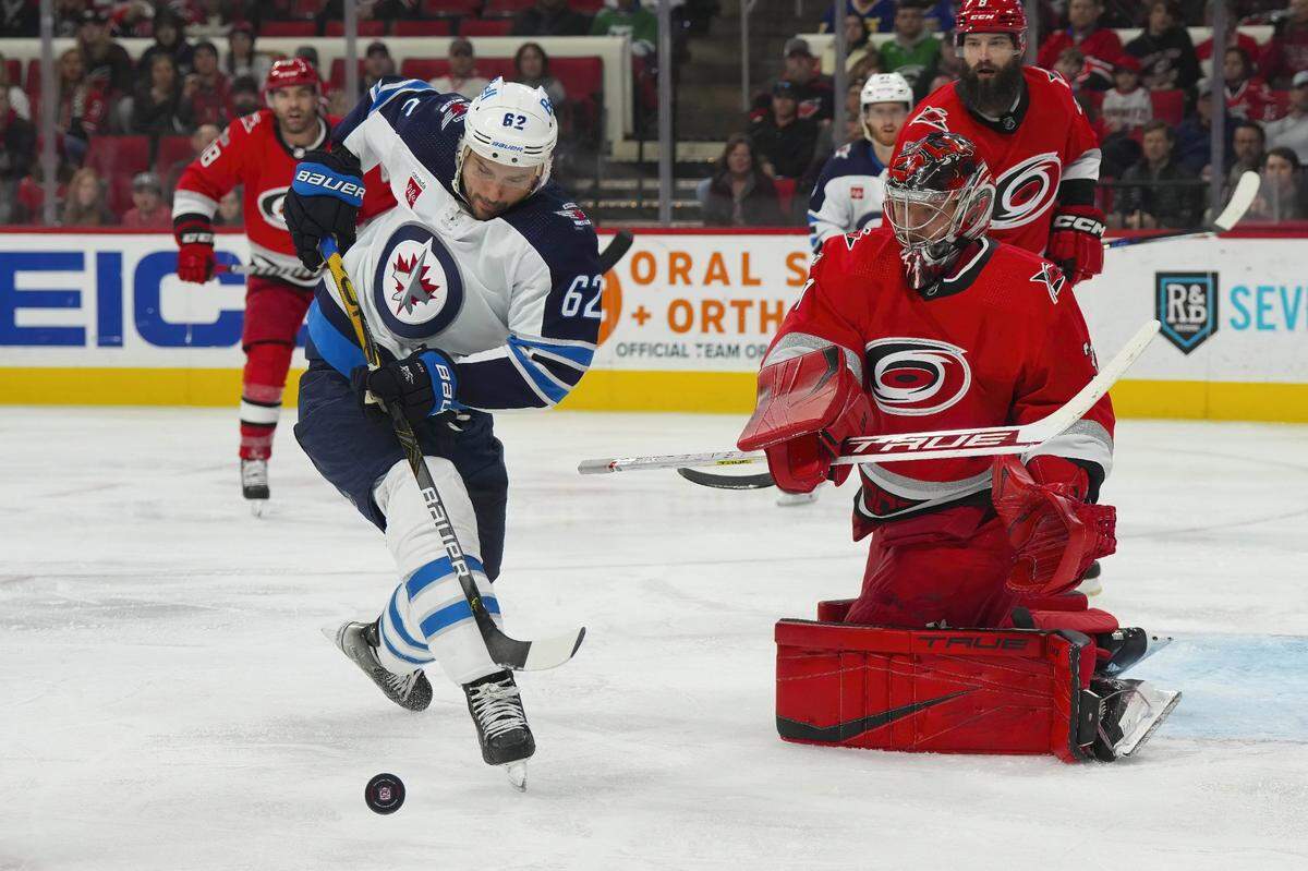 Mar 14, 2023; Raleigh, North Carolina, USA; Winnipeg Jets right wing Nino Niederreiter (62) goes for the rebound against Carolina Hurricanes goaltender Frederik Andersen (31) during the second period at PNC Arena. Mandatory Credit: James Guillory-USA TODAY Sports