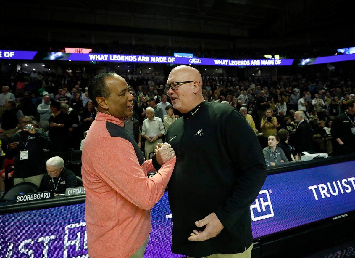 N.C. State head coach Kevin Keatts and Wake Forest head coach Steve Forbes greet each other prior to their teams’ game on Saturday, Feb. 10, 2024, at Lawrence Joel Veterans Memorial Coliseum in Winston-Salem, N.C.
