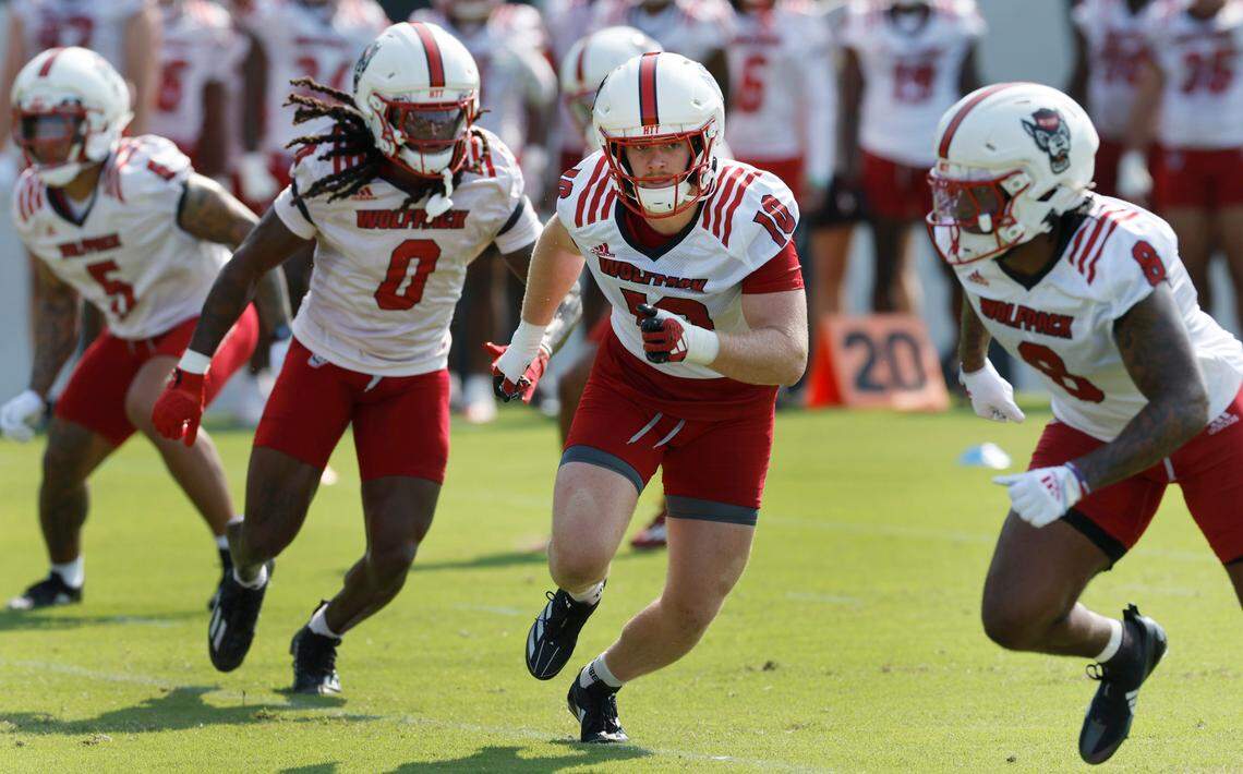 N.C. State linebacker Caden Fordham (10) and the defense run drills during the Wolfpack’s first practice in Raleigh, N.C., Wednesday, July 31, 2024.