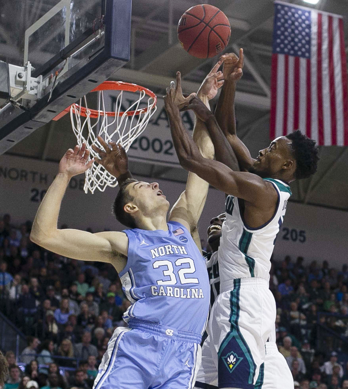 North Carolina’s Justin Pierce (32) battles for an offensive rebound with UNC-W’s Mike Okauru (4) during the first half on Friday, November 8, 2019 at Trask Coliseum in Wilmington, N.C.
