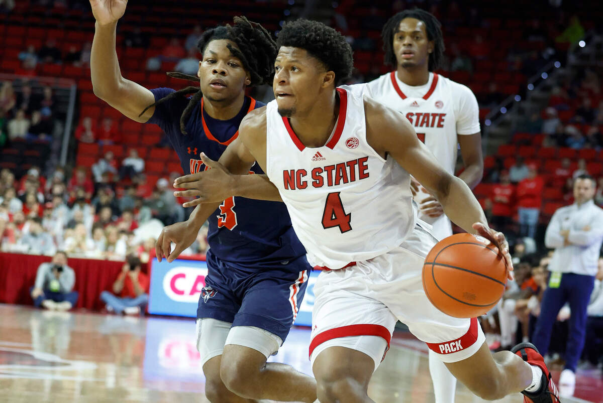 N.C. State’s LJ Thomas (4) drives around UT Martin’s Jordan Sears (3) during the second half of N.C. State’s 81-67 victory over UT Martin at PNC Arena in Raleigh, N.C., Tuesday, Dec. 12, 2023.