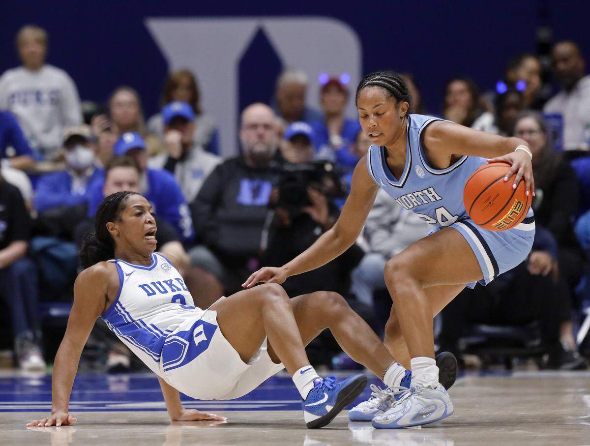 Duke’s Ashlon Jackson takes a charge against North Carolina’s Indya Nivar during the second half of the Blue Devils’ 72-68 win on Sunday, Feb. 15, 2026, at Cameron Indoor Stadium in Durham, N.C.
