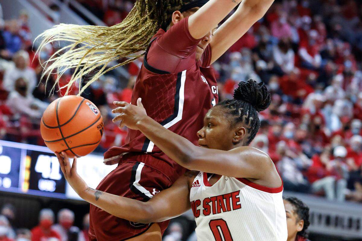 N.C. State’s Diamond Johnson (0) passes around South Carolina’s Kamilla Cardoso (10) during the second half of South Carolinaís 66-57 victory over N.C. State at Reynolds Coliseum in Raleigh, N.C., Tuesday, November 9, 2021.
