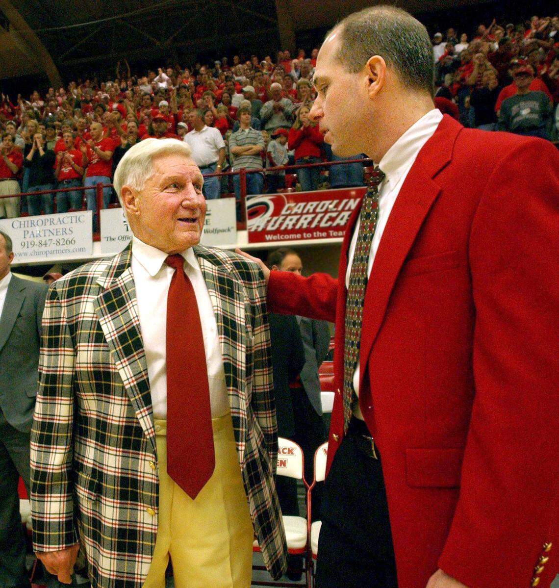 Former N.C. State coach Norm Sloan talks with coach Herb Sendek before the Wolfpack’s game against North Carolina A&T in 2002.
