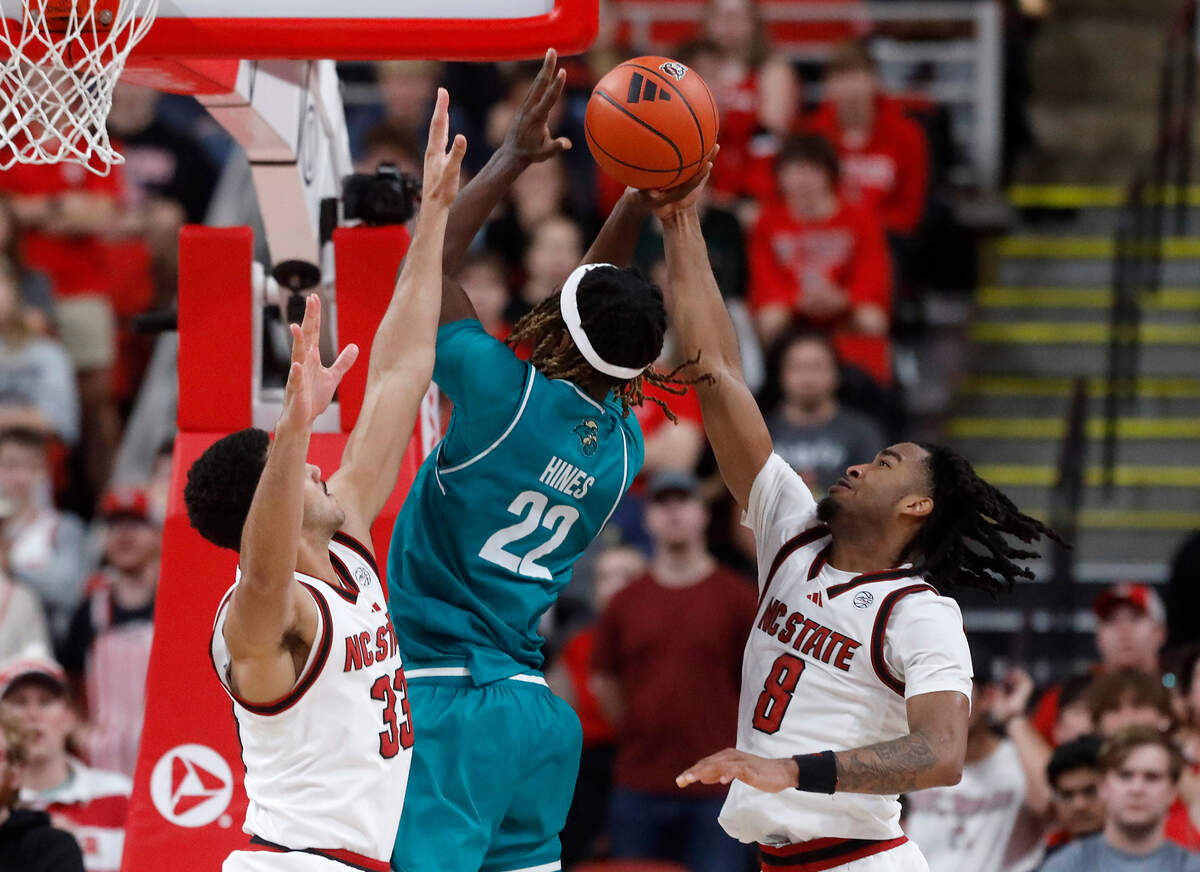 N.C. State’s Ismael Diouf and Jayden Taylor pressure Coastal Carolina’s Denzel Hines during the second half of the Wolfpack’s 82-70 win on Wednesday, Nov. 13, 2024, at Lenovo Center in Raleigh, N.C.