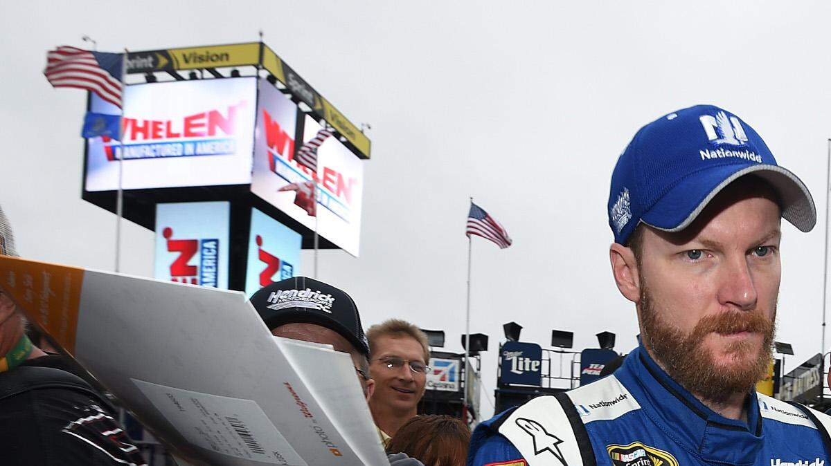 Dale Earnhardt Jr., driver of the #88 Nationwide Chevrolet, signs autographs for race fans during practice for the NASCAR Sprint Cup Series 5-Hour Energy 301 at New Hampshire Motor Speedway on July 18, 2015 in Loudon, New Hampshire. (Photo by Rainier Ehrhardt/Getty Images)