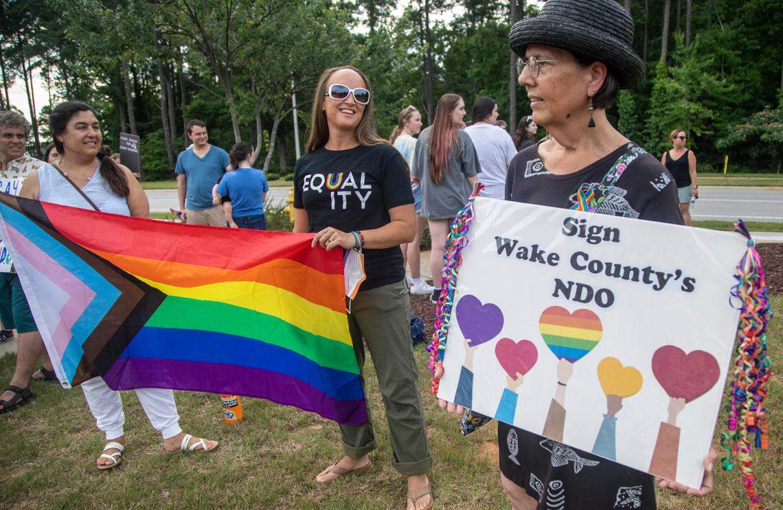 About 50 demonstrators rally outside the Holly Springs Law Enforcement Center to urge the town council to sign a Pride Month proclamation and adopt a non-discrimination ordinance. Holly Springs Mayor Sean Mayefskie refused to sign the proclamation. He said then that the town already has “diverse and inclusive” policies.