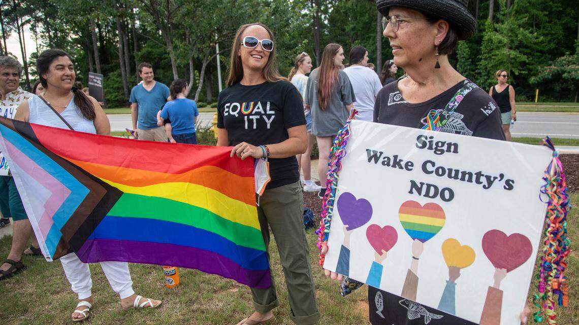About 50 demonstrators rally outside the Holly Springs Law Enforcement Center to urge the town council to sign a Pride Month proclamation and adopt a non-discrimination ordinance. Holly Springs Mayor Sean Mayefskie refused to sign the proclamation. He said then that the town already has “diverse and inclusive” policies.
