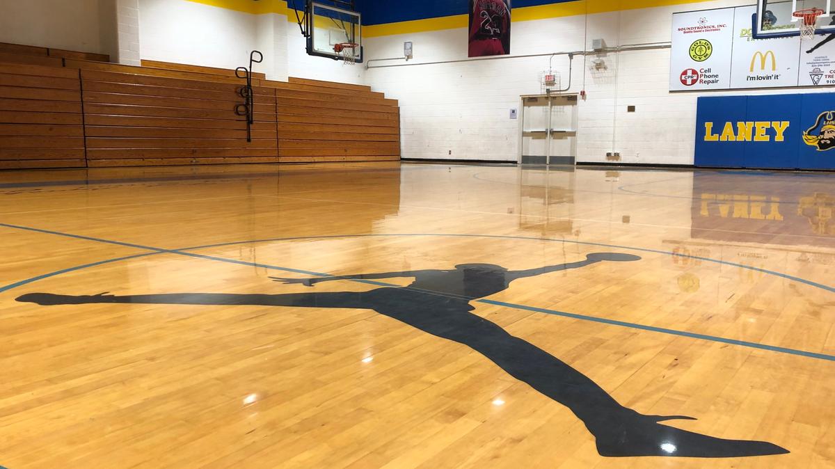 The Jordan Brand logo sits at center court in Laney High’s old gymnasium, where Michael Jordan once played.