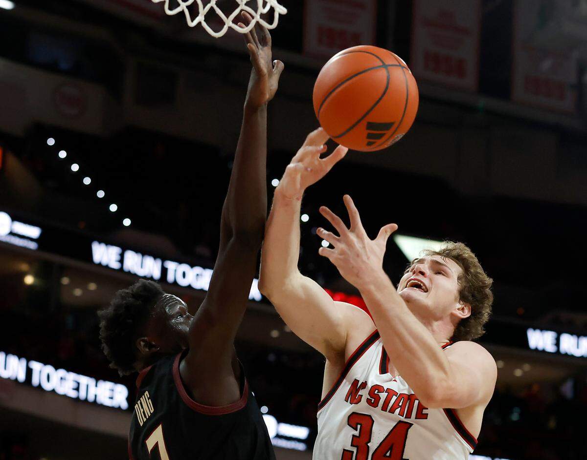 N.C. State’s Ben Middlebrooks battles for a loose ball with Florida State’s Jerry Deng during the first half of the Wolfpack’s game on Saturday, Dec. 7, 2024, at Lenovo Center in Raleigh, N.C.