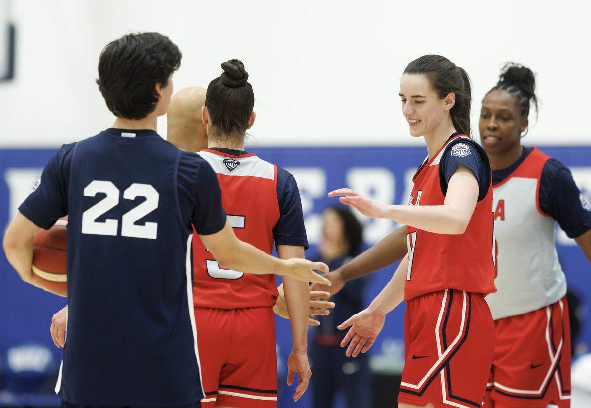 Caitlin Clark high-fives teammates after completing a drill at USA Basketball Women’s National Team training camp on Friday, Dec. 12, 2025, in Durham, N.C.
