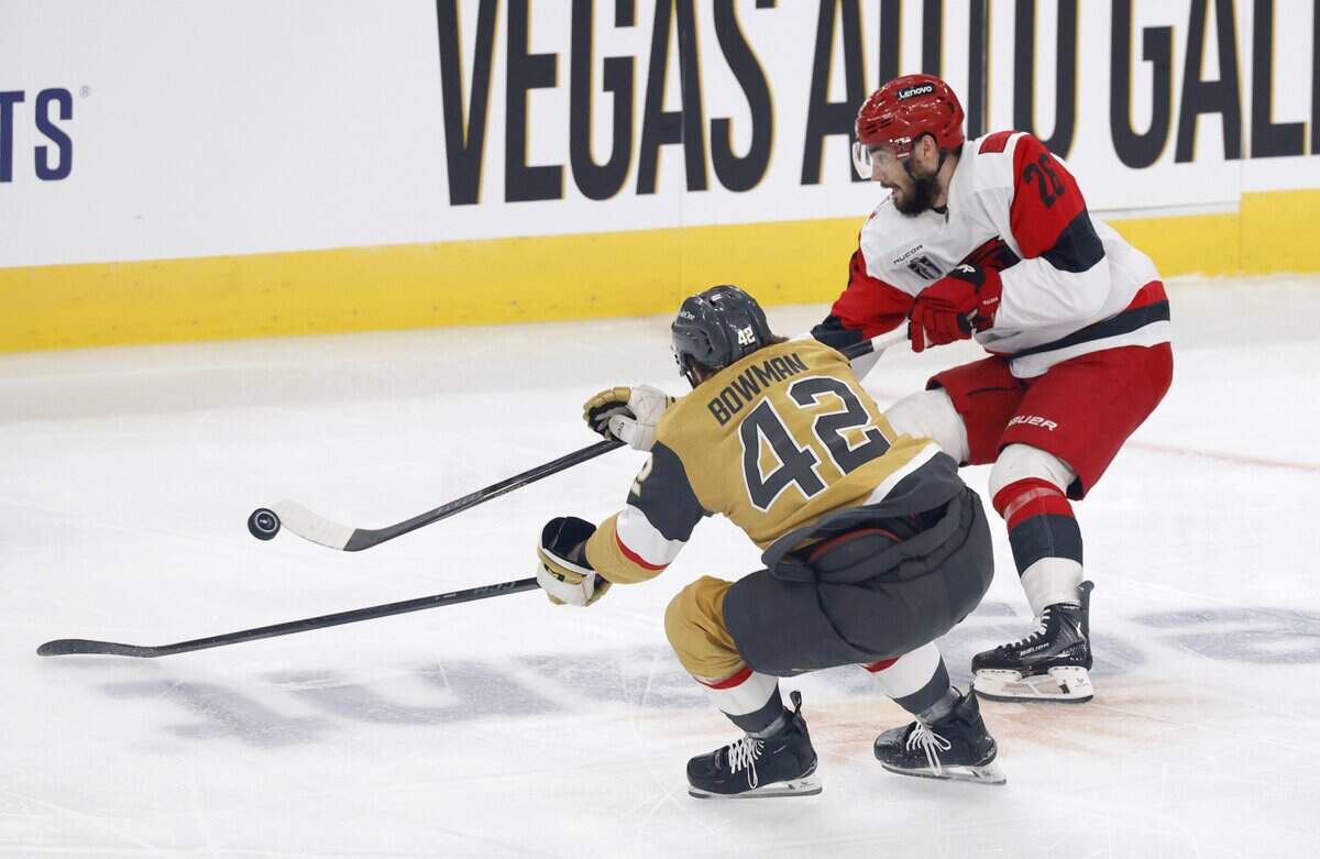 Carolina's Sean Walker (26) passes the puck while defended by Vegas’ Braeden Bowman (42) during the first period of the Hurricanes’ game against the Golden Knights in Game 6 of the Stanley Cup Final at T-Mobile Arena in Las Vegas, Nev., Sunday, June 14, 2026.