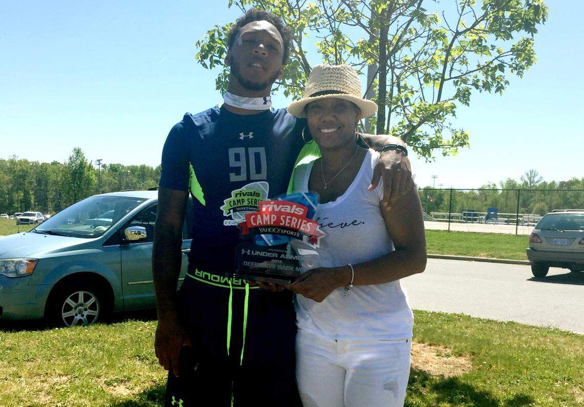 Derrek Pitts poses with his mother, Dionne Beverly-Hairston, after Pitts won defensive MVP at a Rivals football camp during his junior year of high school.