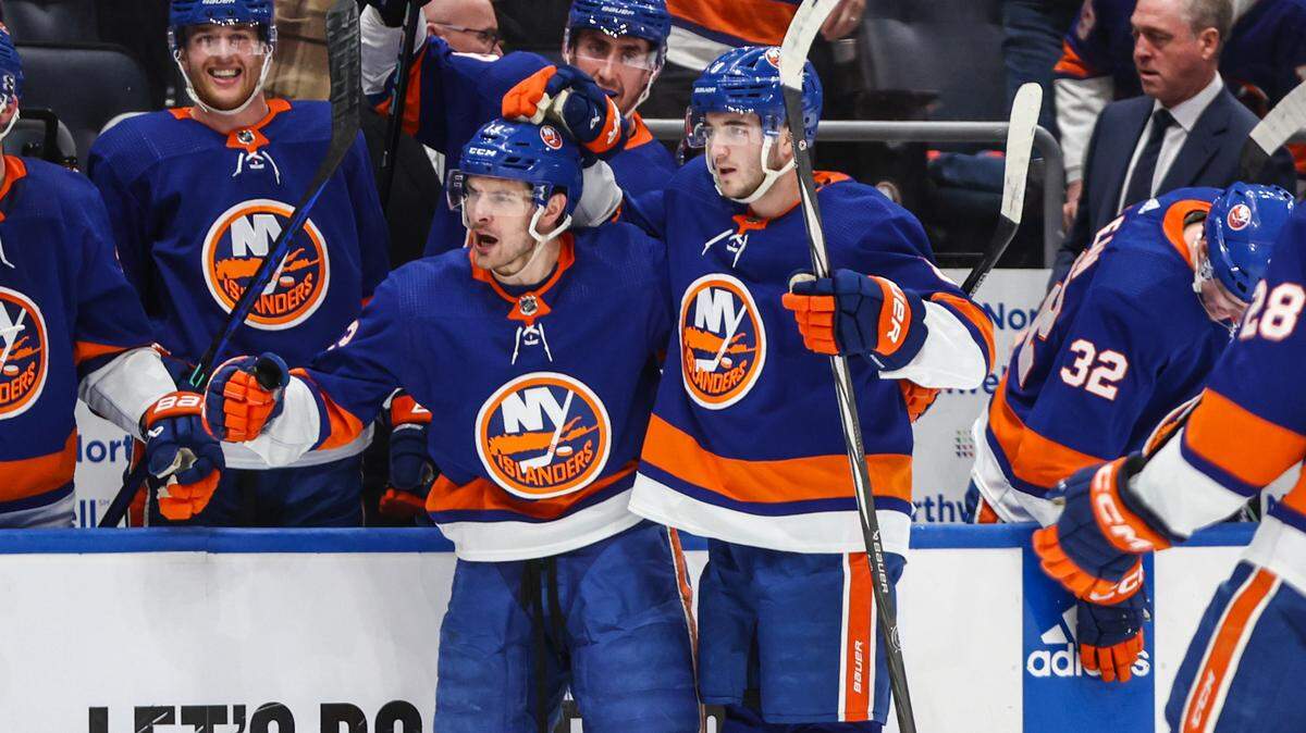 New York Islanders center Mathew Barzal (13) celebrates with defenseman Noah Dobson (8) after scoring a goal in the second period against the Carolina Hurricanes in game four of the first round of the 2024 Stanley Cup Playoffs at UBS Arena.