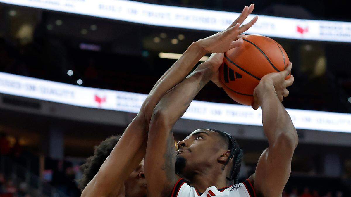 N.C. State’s Marcus Hill (right) drives to the basket against Florida State’s Justin Thomas during overtime of the Wolfpack’s 84-74 win on Saturday, Dec. 7, 2024, at Lenovo Center in Raleigh, N.C.