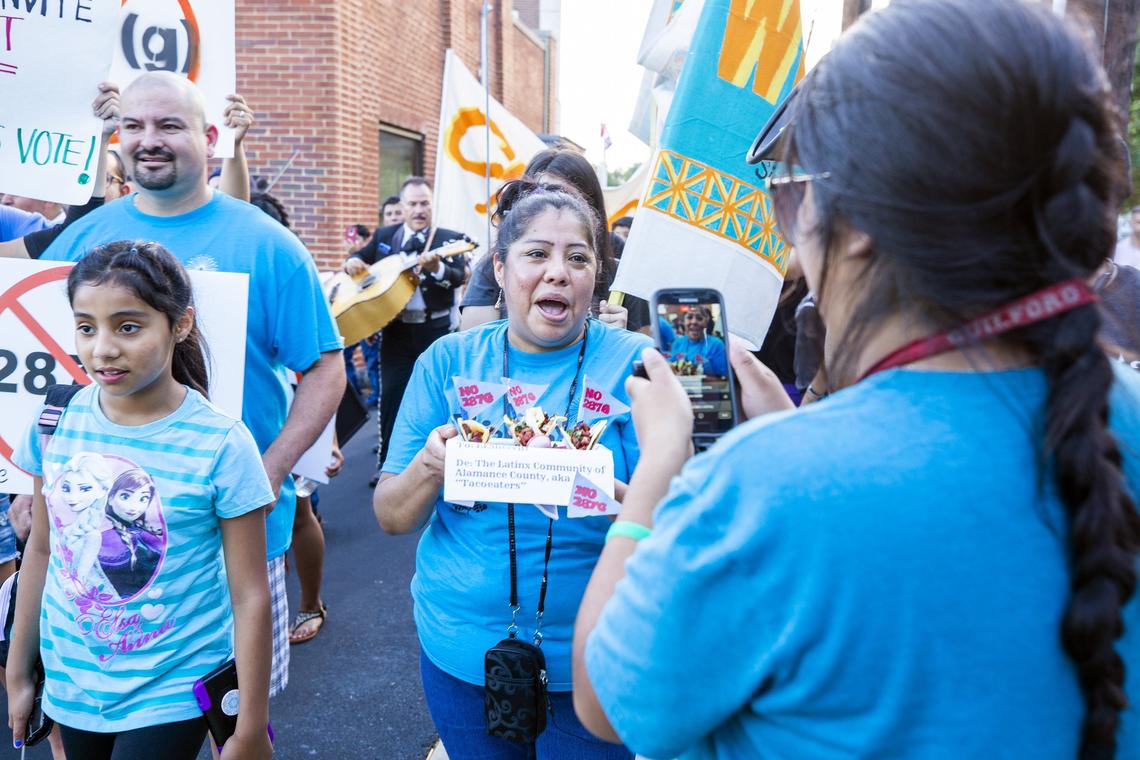 Emma Vasquez marches with fellow protesters to deliver tacos to the office of Alamance County Sheriff Terry Johnson, mocking his reference to Latinos as "taco-eaters" when directing his deputies to arrest motorists who appeared Latino, during a protest opposing the return of an ICE program known as 287g, that allows sheriff deputies to act as immigration agents, outside the Alamance County Superior Court on Wednesday, Jun. 13, 2018, in Graham, NC. Johnson has re-applied for the program even after his department was investigated by the Department of Justice in 2012 for racial profiling against Latinos under the program.