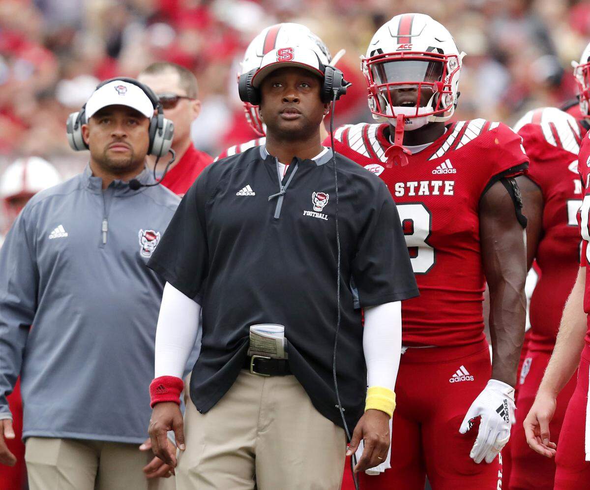 N.C. State wide receivers coach George McDonald watches a replay during the first half of N.C. State’s game against East Carolina University at Carter-Finley Stadium in Raleigh, N.C., Saturday, Dec. 1, 2018.