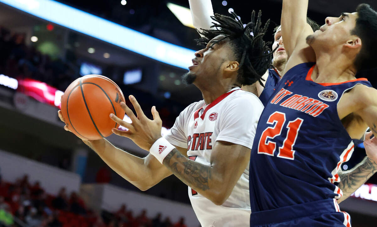 N.C. State’s Jayden Taylor (1) shoots while defended by UT Martin’s Sebastian Mendoza (21) during the second half of N.C. State’s 81-67 victory over UT Martin at PNC Arena in Raleigh, N.C., Tuesday, Dec. 12, 2023.