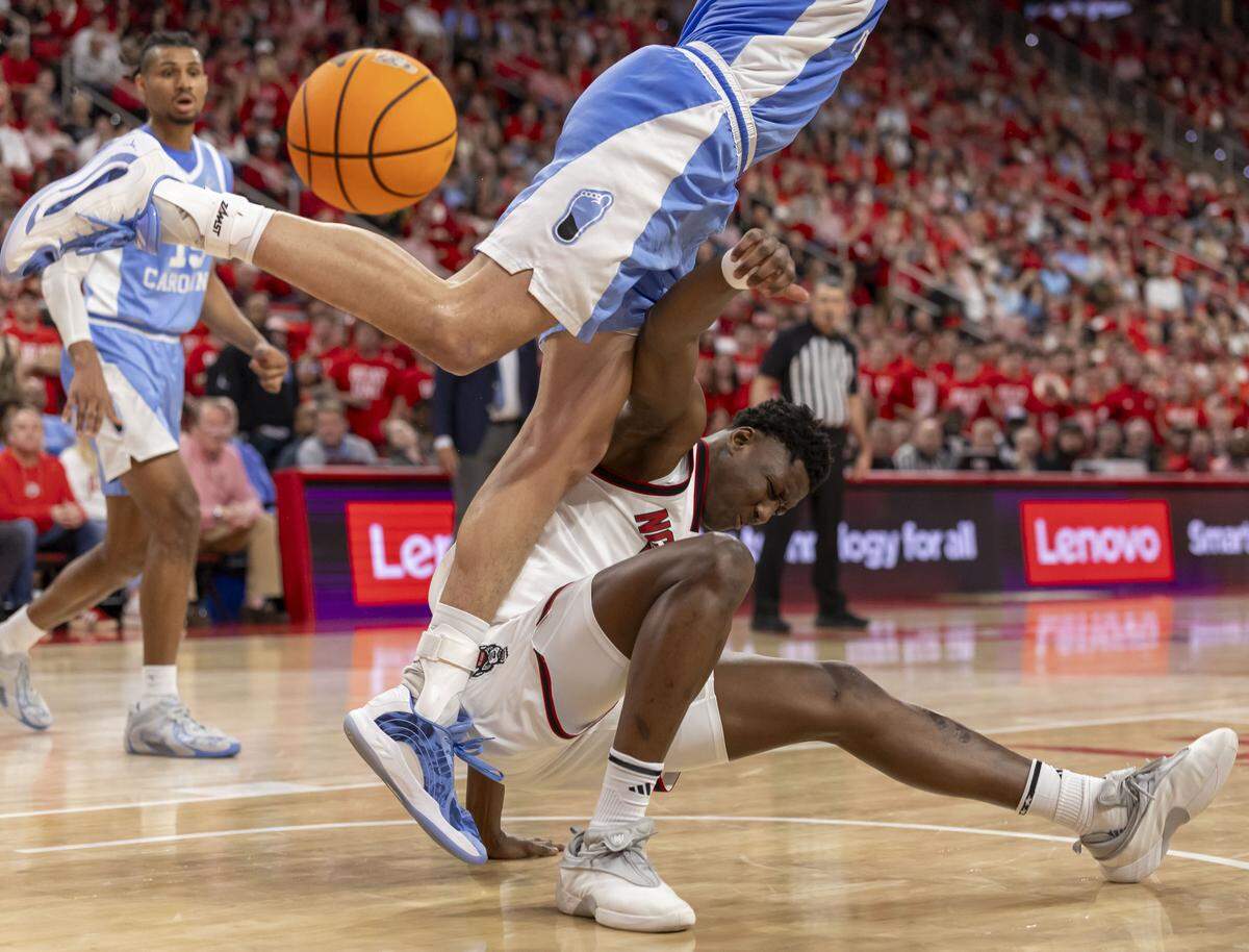 North Carolina center Zayden High (1) collides with N.C. State’s Musa Sagnia (13) in the first half on Tuesday, February 17, 2026 at Lenovo Center in Raleigh, N.C.