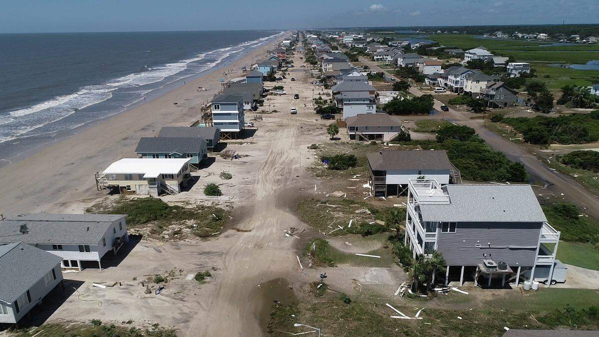 Oak Island sustained wind and flood damage caused by Hurricane Isaias leaving the streets strewn with debris and covered with more than a foot of sand in areas close to the beach Tuesday, August 4, 2020.