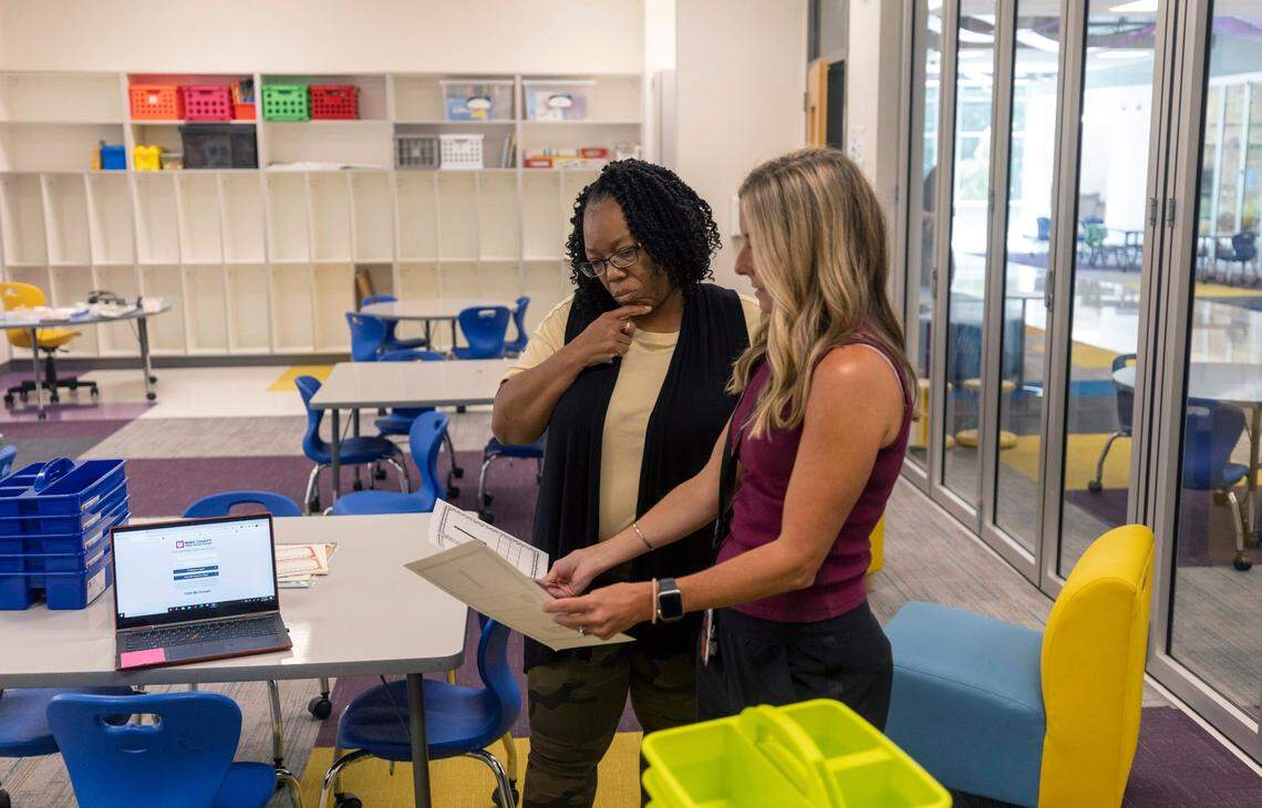 Instructional Assistant Sherry C. Spencer and first grade teacher Cindy Fields work to set up their classroom on the first of a series of teacher work days in preparation for the new school year on August 17, 2022 in Raleigh, N.C.