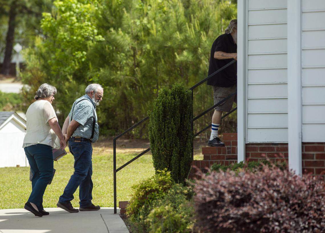 Members of the congregation at New Life Baptist Church in Smithfield, N.C., enter into the sanctuary to worship indoors with pastor Steve Grice on Sunday, May 17, 2020. Grice had announced they would be defying Gov. Roy Cooper’s executive order to limit gatherings to 10 people in an effort to slow the spread of COVID-19. A federal judge blocked those restrictions on Saturday, May 16, 2020.